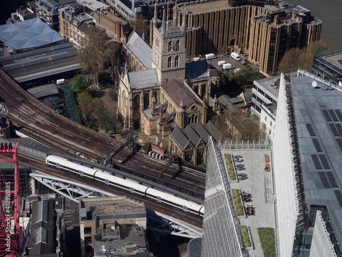 aerial view of Southwark Cathedral seen from the Shard building with modern roof top garden and railway in foreground photo