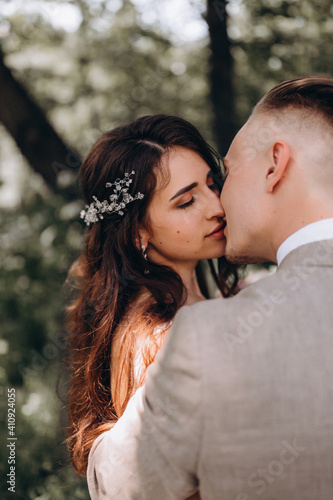 Walking the bride and groom outdoors. Beautiful summer photo session in nature.