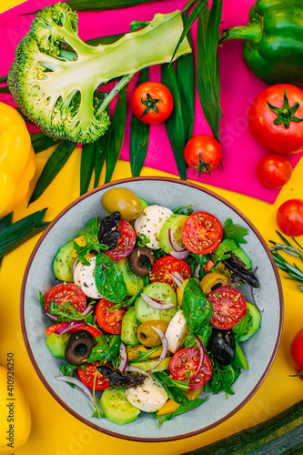healthy food. Greek Salad with cheese, cucumbers, tomatoes and olives on a decorated table