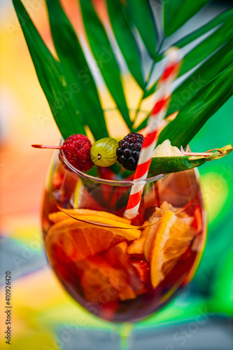 tropical cocktail with berries and fruits on a decorated table
