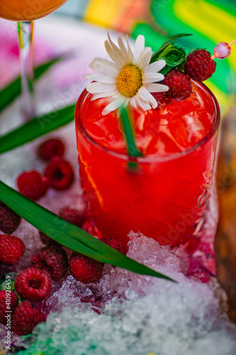 tropical cocktail with berries and fruits on a decorated table