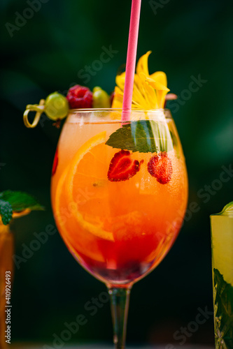 tropical cocktail with berries and fruits on a decorated table