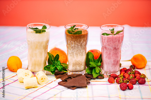 milkshake with berries and fruits on a decorated table