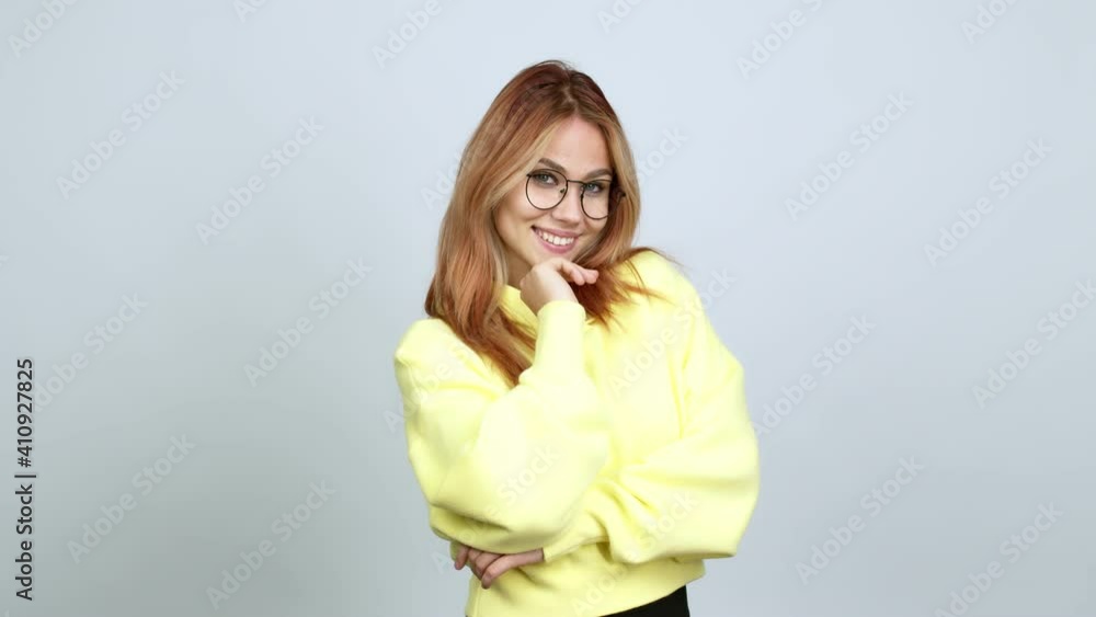 Teenager girl with glasses smiling and looking to the front with confident face over isolated background Teenager girl with glasses smiling and looking to the front with confident face over isolated background