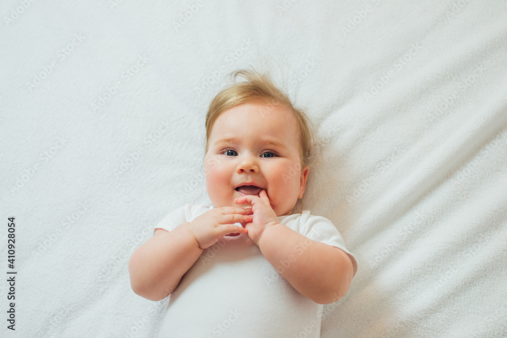 Cute little baby lying on white sheets, top view Cute little baby lying on white sheets, top view