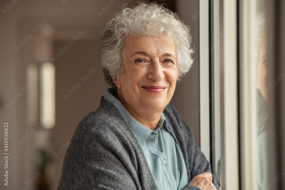 Happy senior woman smiling at home - obrazy, fototapety, plakaty 