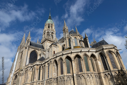 Bayeux France 10.18.2019 exterior of cathedral rising up a low angle to blue sky