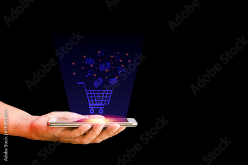 Shop online concept. Hand hold smartphone with shopping cart, search, credit card and bag virtual icon on blue background. Quarantine to save life from corona virus.