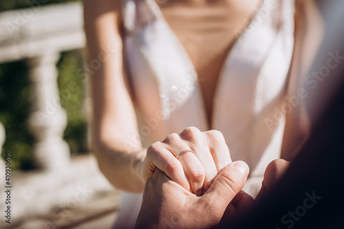 Groom holding bride hand with ring