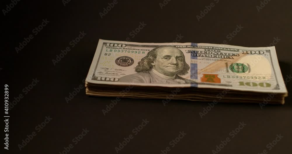 Dollar Banknotes, 100 Dollar Bills. Cash piling up on dark Background Dollar Banknotes, 100 Dollar Bills. Cash piling up on dark Background