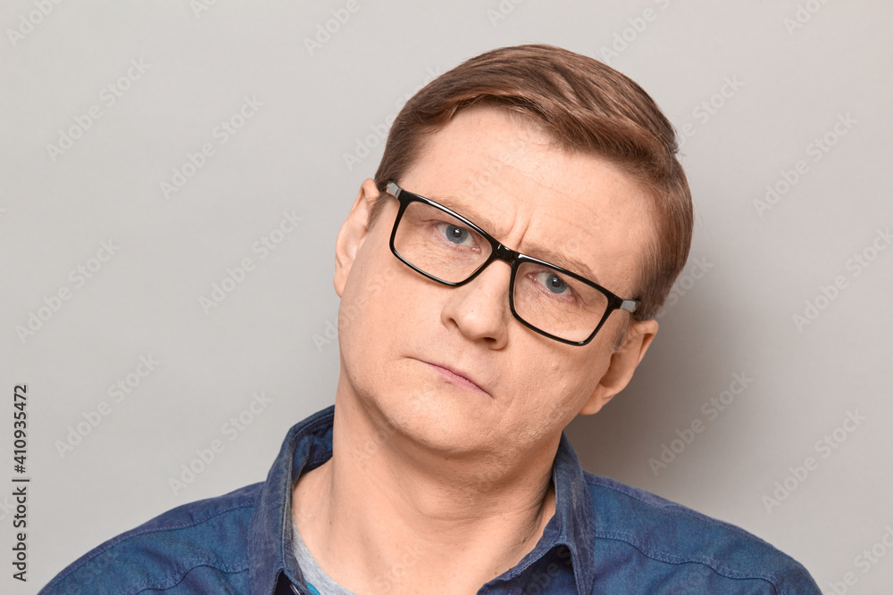 Portrait of mature man with glasses with serious expression on face