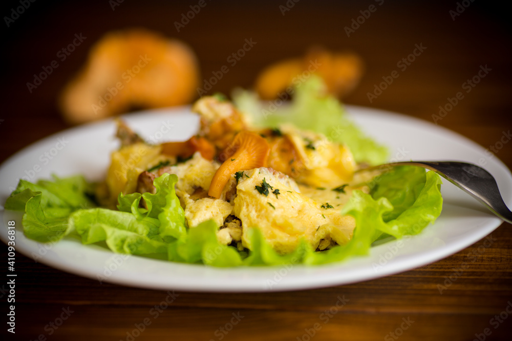 fried omelet with forest mushrooms chanterelles, on table fried omelet with forest mushrooms chanterelles, on table