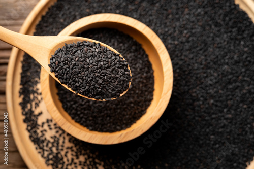 Close up black Sesame on wooden spoon background