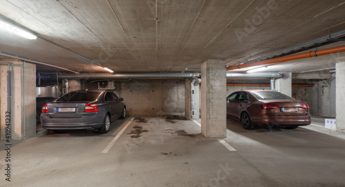 Cars on underground parking in modern residential complex.