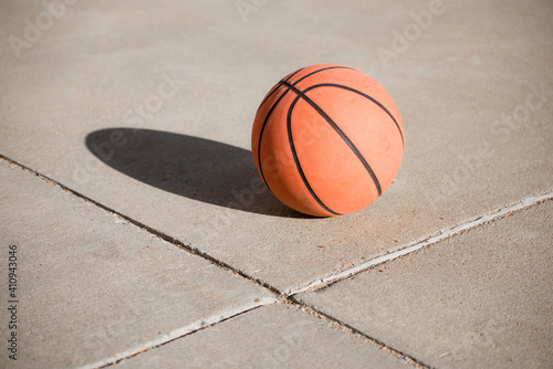 Basketball and shadow on concrete court © LightcrafterArtistry