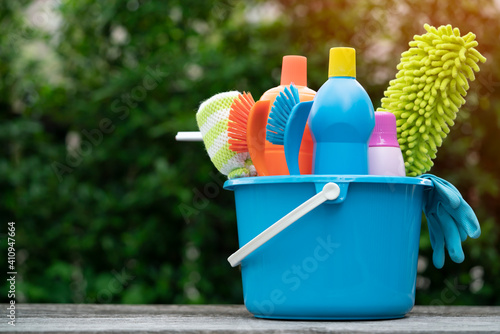 House cleaning product on wood table with blue background, home service or housekeeping concept