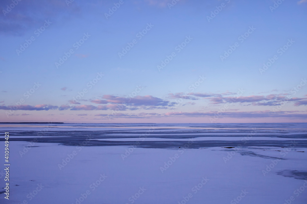 Gorgeous winter landscape of icy frozen lake like a desert, background with copy space, winter romantic, silence and wild nature
