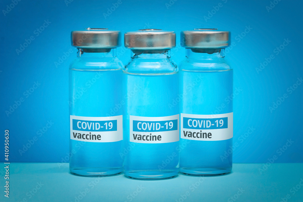 Covid injection vaccine vials with medication for coronavirus sars on blue background. Close up of vaccine Covid-19 ampoules Covid injection vaccine vials with medication for coronavirus sars on blue background. Close up of vaccine Covid-19 ampoules