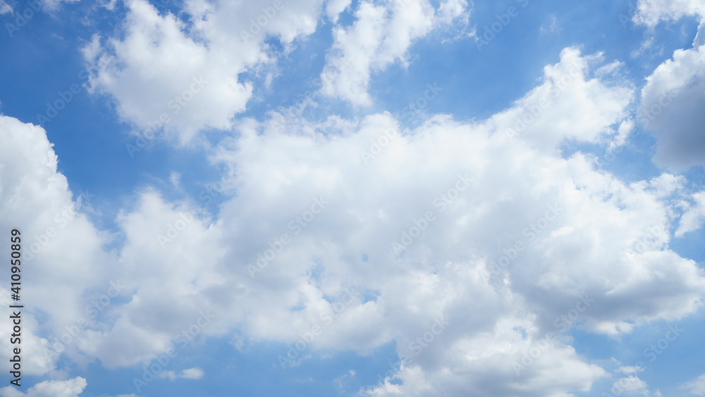 Summer sky is bright blue. There are clouds floating through. Feel relax when looking. See the sun on the sun.