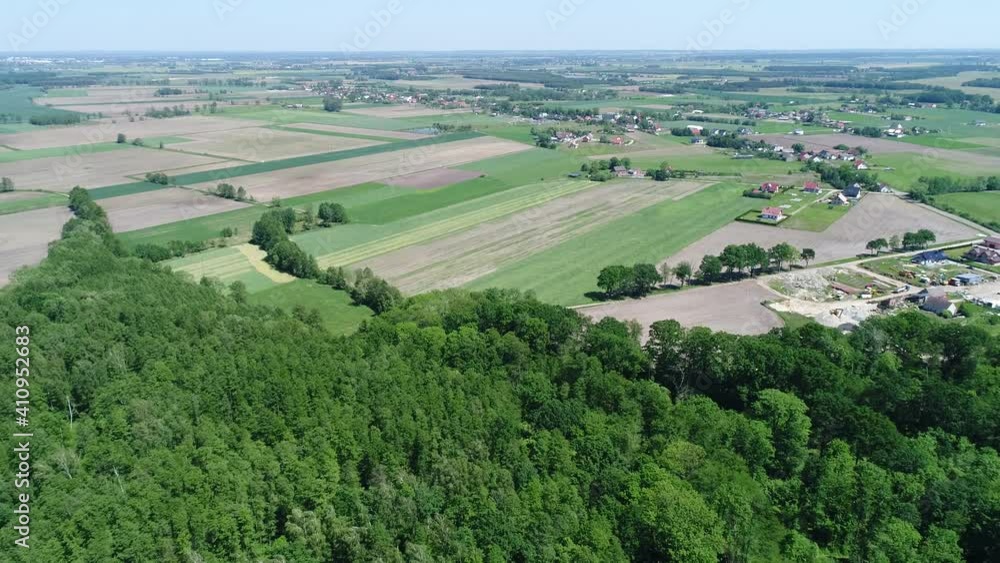 A beautiful landscape of Polish villages, forests and framed fields. Sunny day with a blue sky, green vegetation and trees in the video from the drone A beautiful landscape of Polish villages, forests and framed fields. Sunny day with a blue sky, green vegetation and trees in the video from the drone