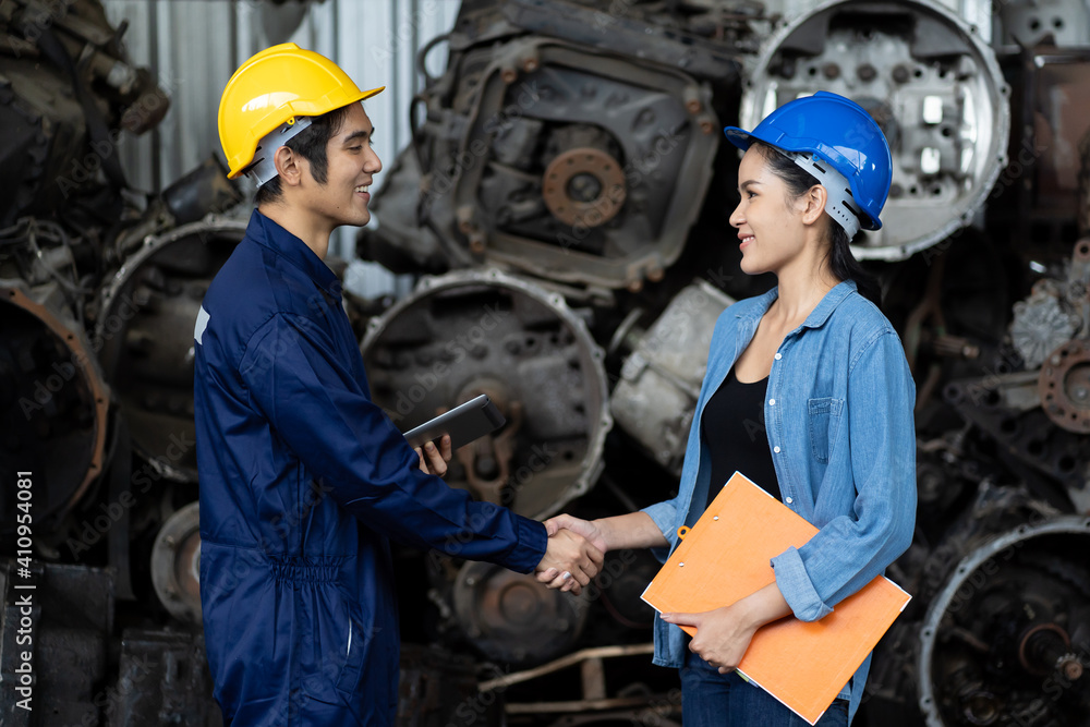 Fototapeta premium Group of Asian male and female worker successful of work at old garage parts storage warehouse