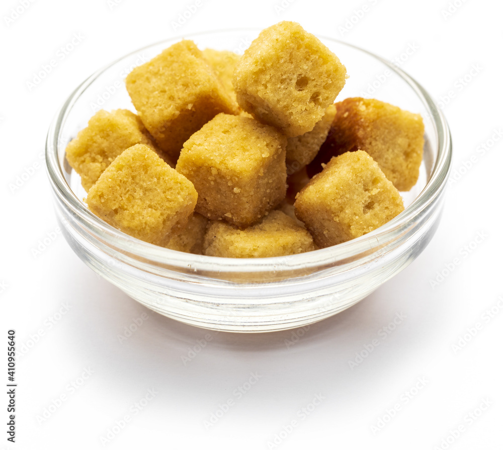 Bowl of crispy croutons. Cubes of bread toasted and fried in oil. Isolated white background Bowl of crispy croutons. Cubes of bread toasted and fried in oil. Isolated white background