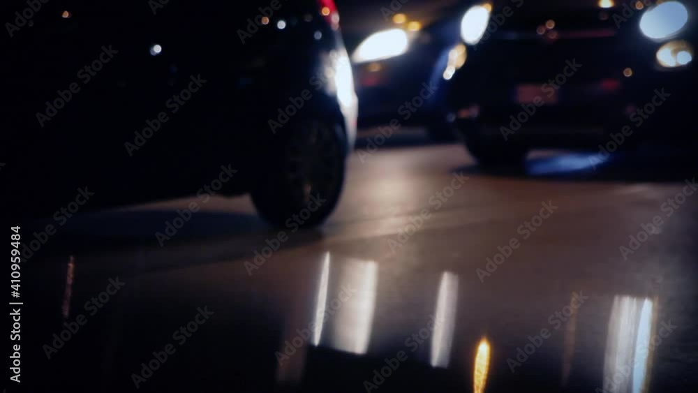 Cars stopping and going on a busy street at night, defocused lights.
Cars stopping and going on a busy street at night, defocused lights.
