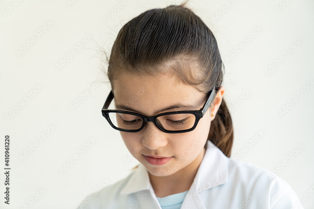 Child girl scientists learning science wearing white uniform and glasses in classroom or laboratory. Early development of children. Medical, Lab, Scientific experiment, Researcher, Research concept Child girl scientists learning science wearing white uniform and glasses in classroom or laboratory. Early development of children. Medical, Lab, Scientific experiment, Researcher, Research concept