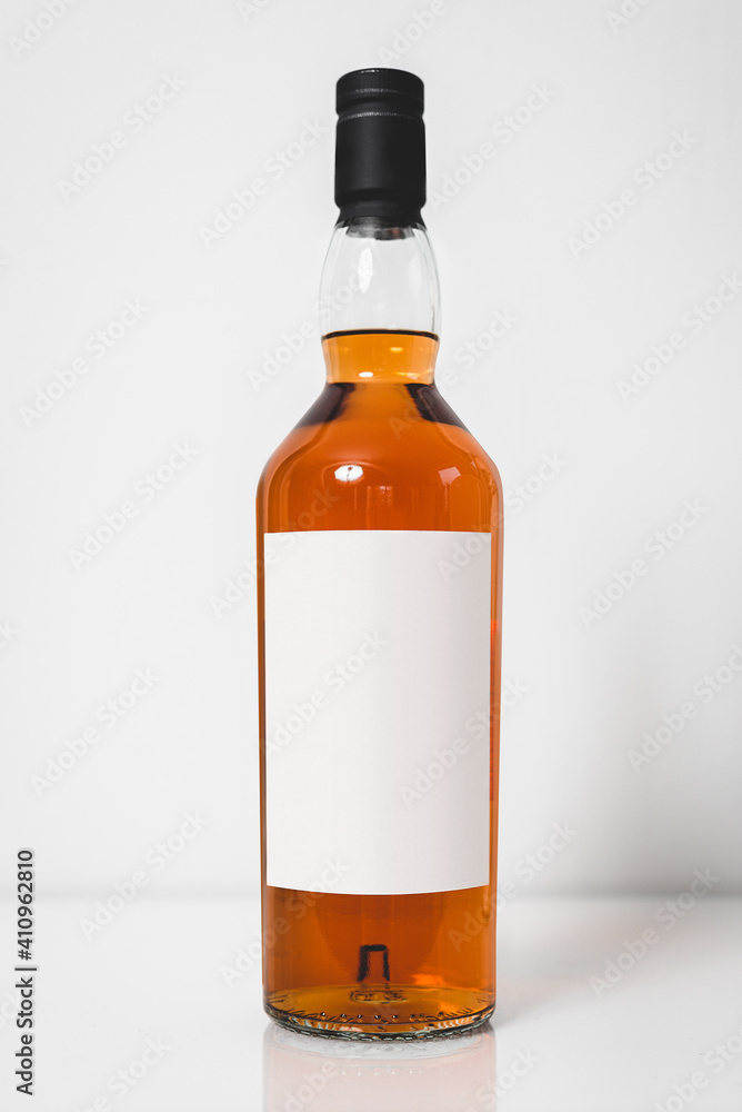 Wiskey bottle branding photo. Mock up glass bottle full with bourbon alcohol. Studio shot. Empty label.
Wiskey bottle branding photo. Mock up glass bottle full with bourbon alcohol. Studio shot. Empty label.