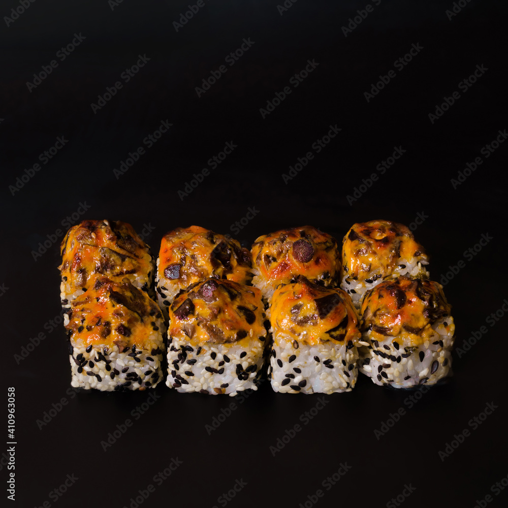 baked eel rolls on a black background baked eel rolls on a black background