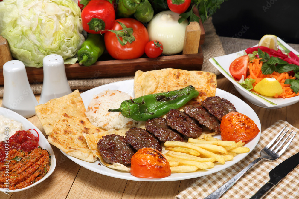 grilled meatballs with rice pilaf and fried potato and grilled tomata green pepper grilled meatballs with rice pilaf and fried potato and grilled tomata green pepper