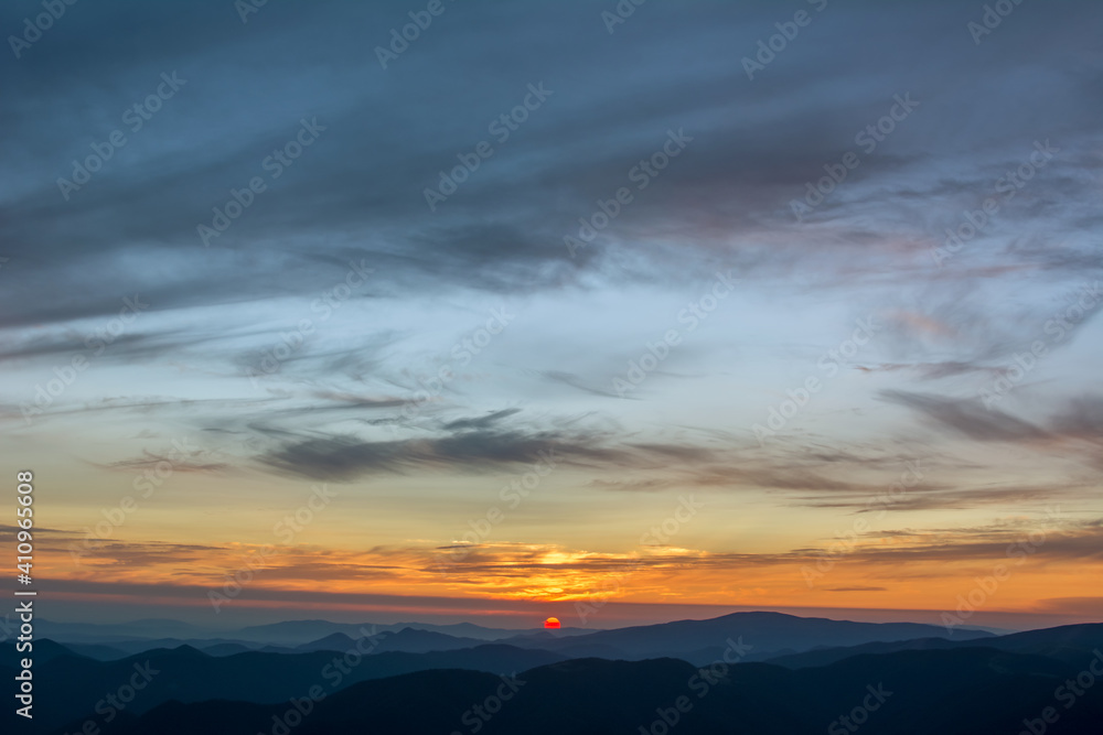 The first or last rays of the sun on a mountain pass. Morning and evening in nature. Colorful sunset and sunrise over the mountain hills. Carpathians in summer and autumn. The first or last rays of the sun on a mountain pass. Morning and evening in nature. Colorful sunset and sunrise over the mountain hills. Carpathians in summer and autumn.