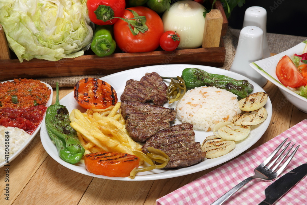 grilled beef steak with grilled tomatoes, pepper, and potatoes fries grilled beef steak with grilled tomatoes, pepper, and potatoes fries