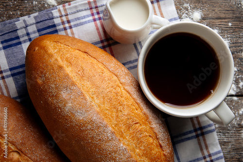 Closeup on loafs of yeast-free bread with coffee on the wooden cutting board photo