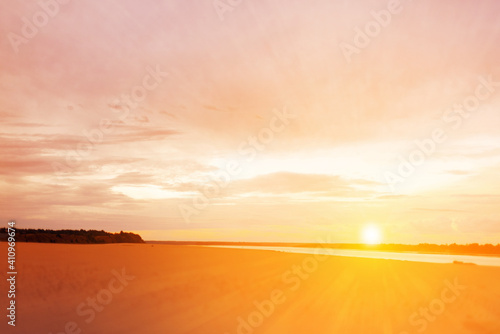 beach lit by sunset. copy space. Sunset over the river beach