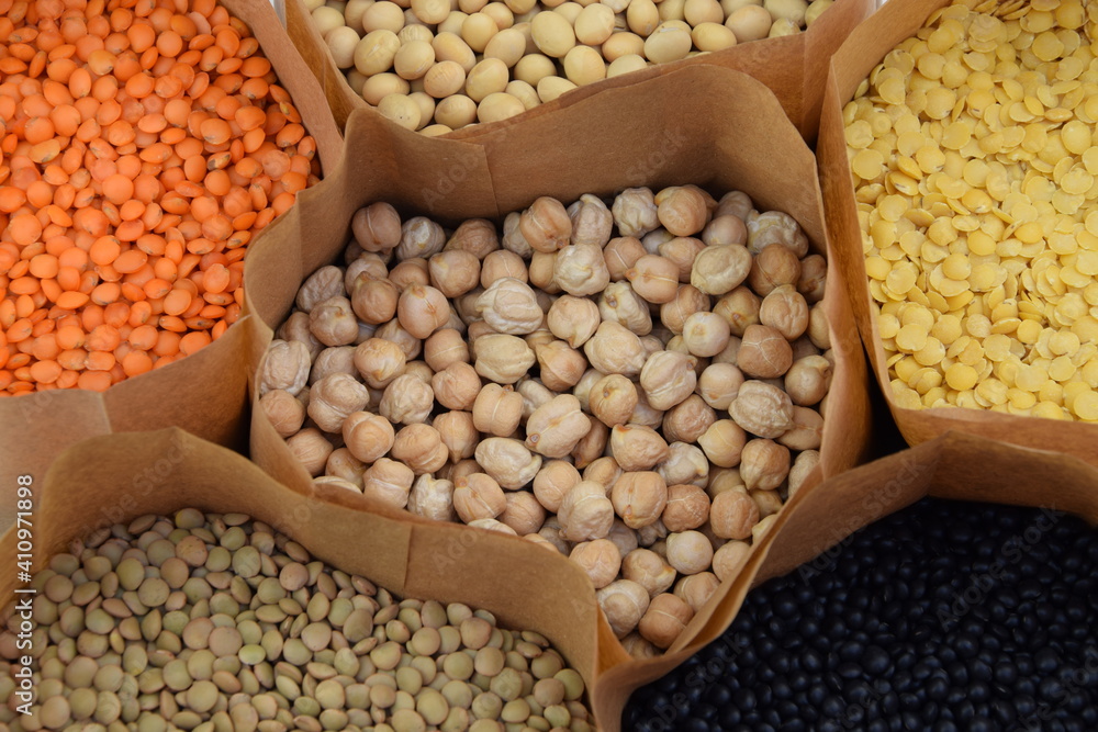 Obraz premium Chickpea, lentils different lentils, soybean on paper bags, colorfull legumes