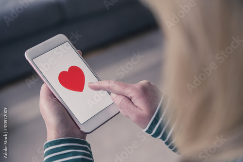 Girl using a touchscreen mobile phone to find love in online dating app