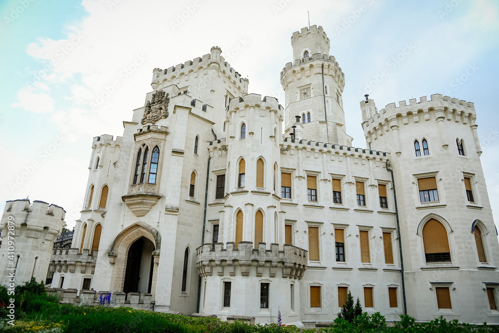 White beautiful state Chateau of Hluboka, neo-Gothic castle and gardens on a sunny summer day, famous national cultural landmark, Hluboka nad Vltavou, South Bohemia, Czech Republic