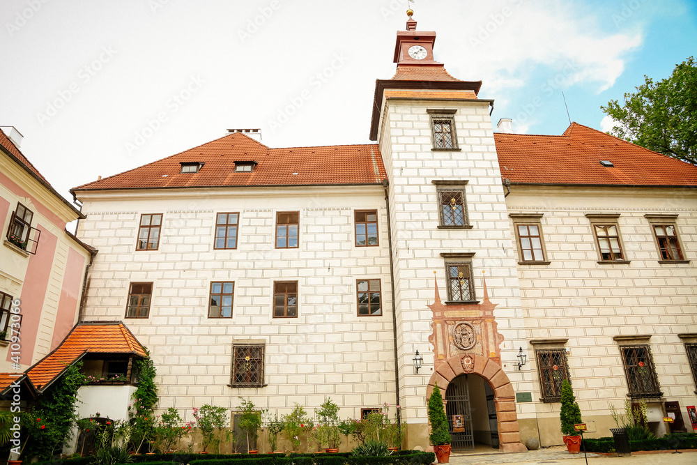 Courtyard of Trebon Castle, Renaissance chateau, palace architecture and park with fountain, sunny summer day, historical medieval town with spa, Trebon, South Bohemia, Czech Republic