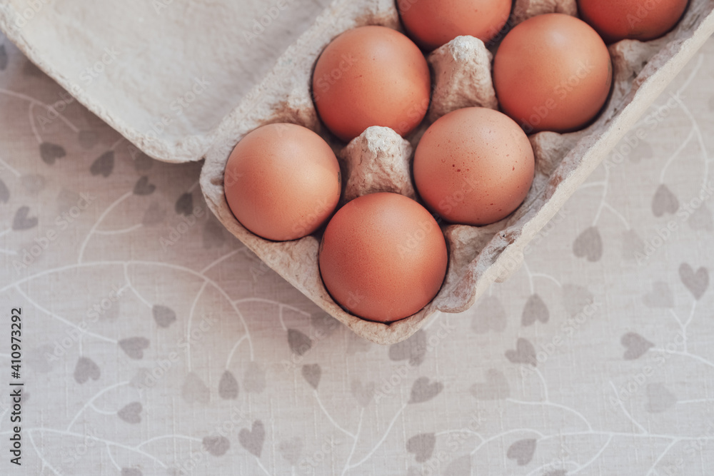 Raw brown eggs in egg box. Top view, copy space Raw brown eggs in egg box. Top view, copy space