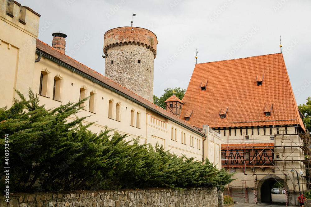 Beautiful historic Tower of Kotnov gothic castle behind town fortification wall on sunny summer day, Bechynska Gate in romantic medieval city Tabor, South Bohemia, Czech Republic