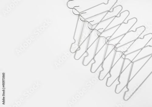 Metal clothes hangers on a light background. Wardrobes were hung for clothes. Place for text