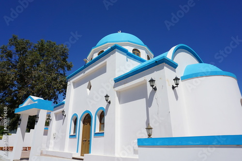 a white blue basilica on a hill in Kefalos, Kos Island, Greece, May photo