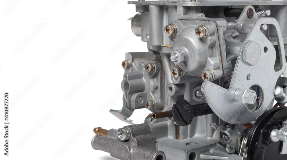 Close up of details of car carburetor against white background, small depth of focus, copy space on the left. Automotive parts. Close up of details of car carburetor against white background, small depth of focus, copy space on the left. Automotive parts.