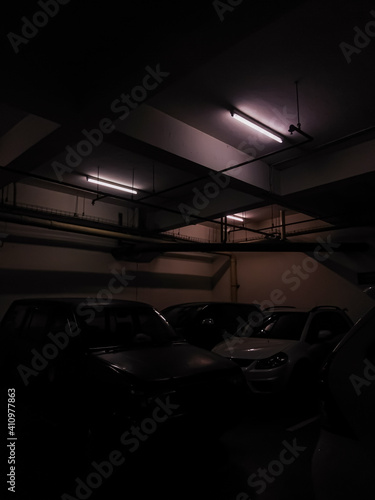 A large parking area, which is located indoors, so it is out of the sun and lit only by fluorescent lights. © Ibra nurlette