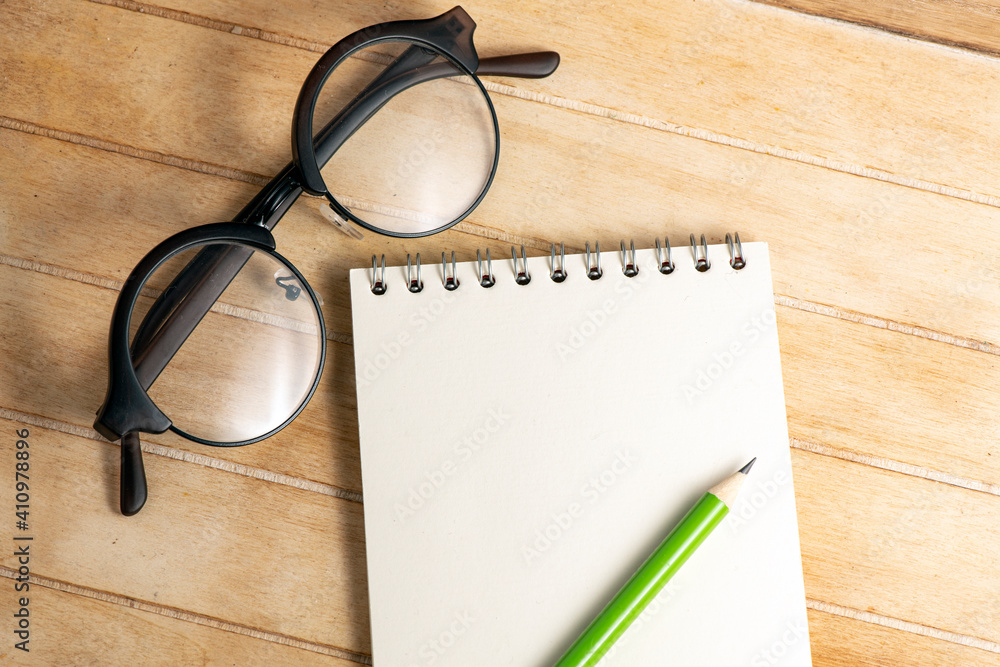 Blank notepad on office wooden table Blank notepad on office wooden table