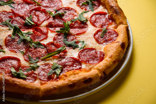 pizza on yellow background, pizza corner, salami, pepperoni, cheese