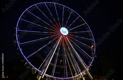 Night view from the bottom of the bright Grande Roue in the Vieux Port of Marseille, France