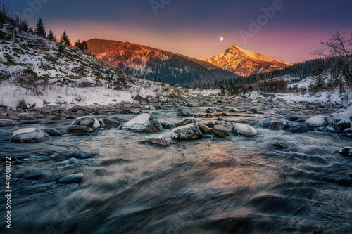 Krivan peak with the moon in full over a mountain river in High Tatras photo