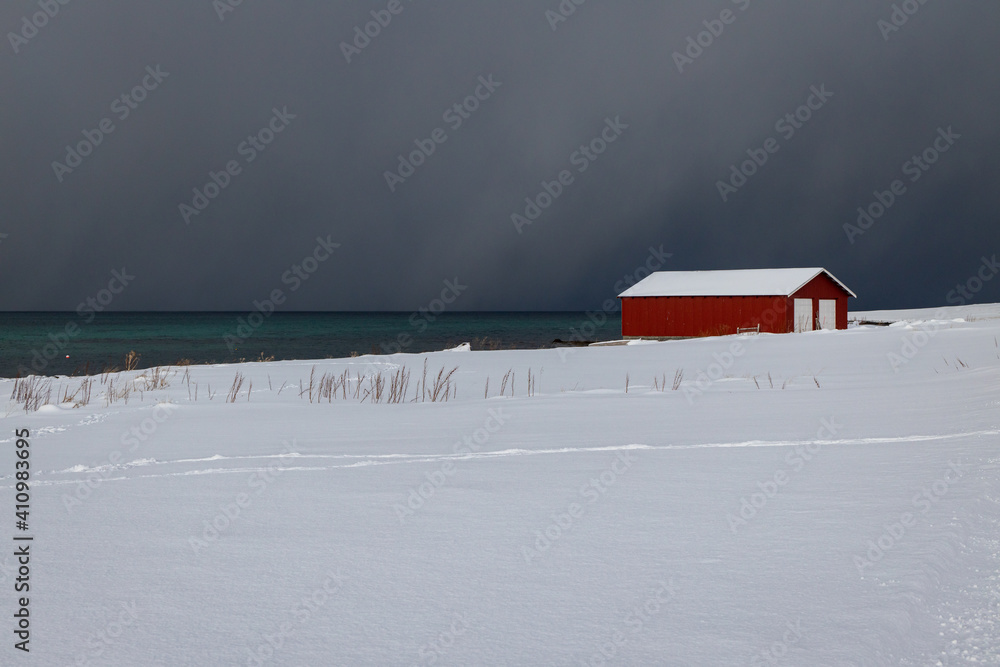 Fisherman's house on the snowy fjord - obrazy, fototapety, plakaty 